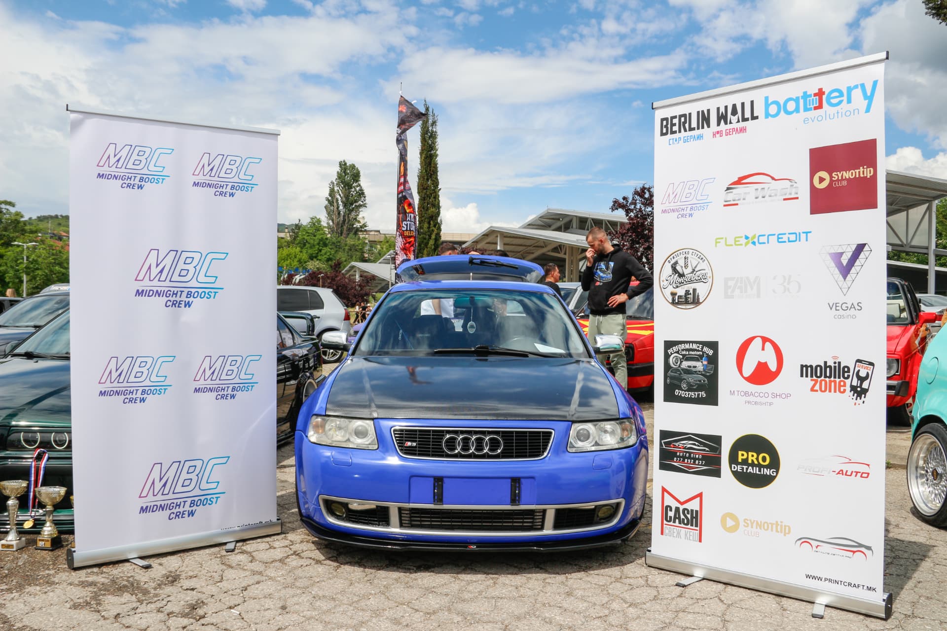 Blue Audi S3 between MBC banners