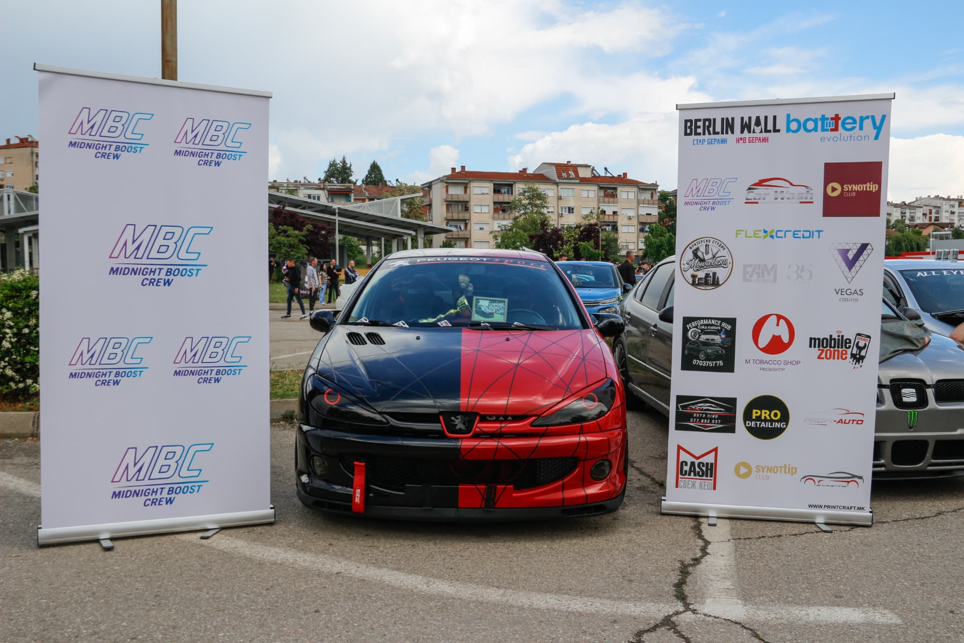 Spiderman-themed Peugeot 206 between MBC banners