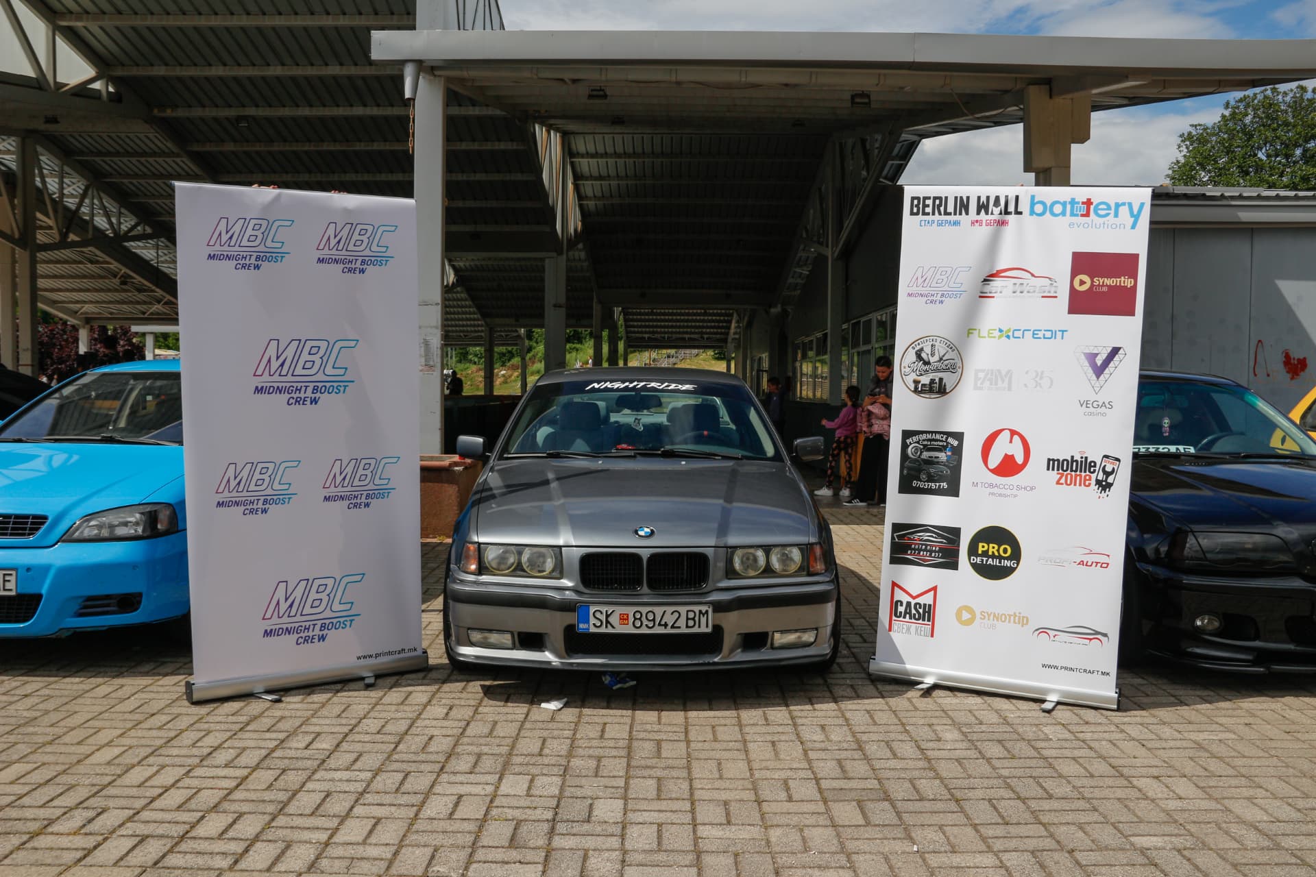 Grey BMW E36 between MBC banners