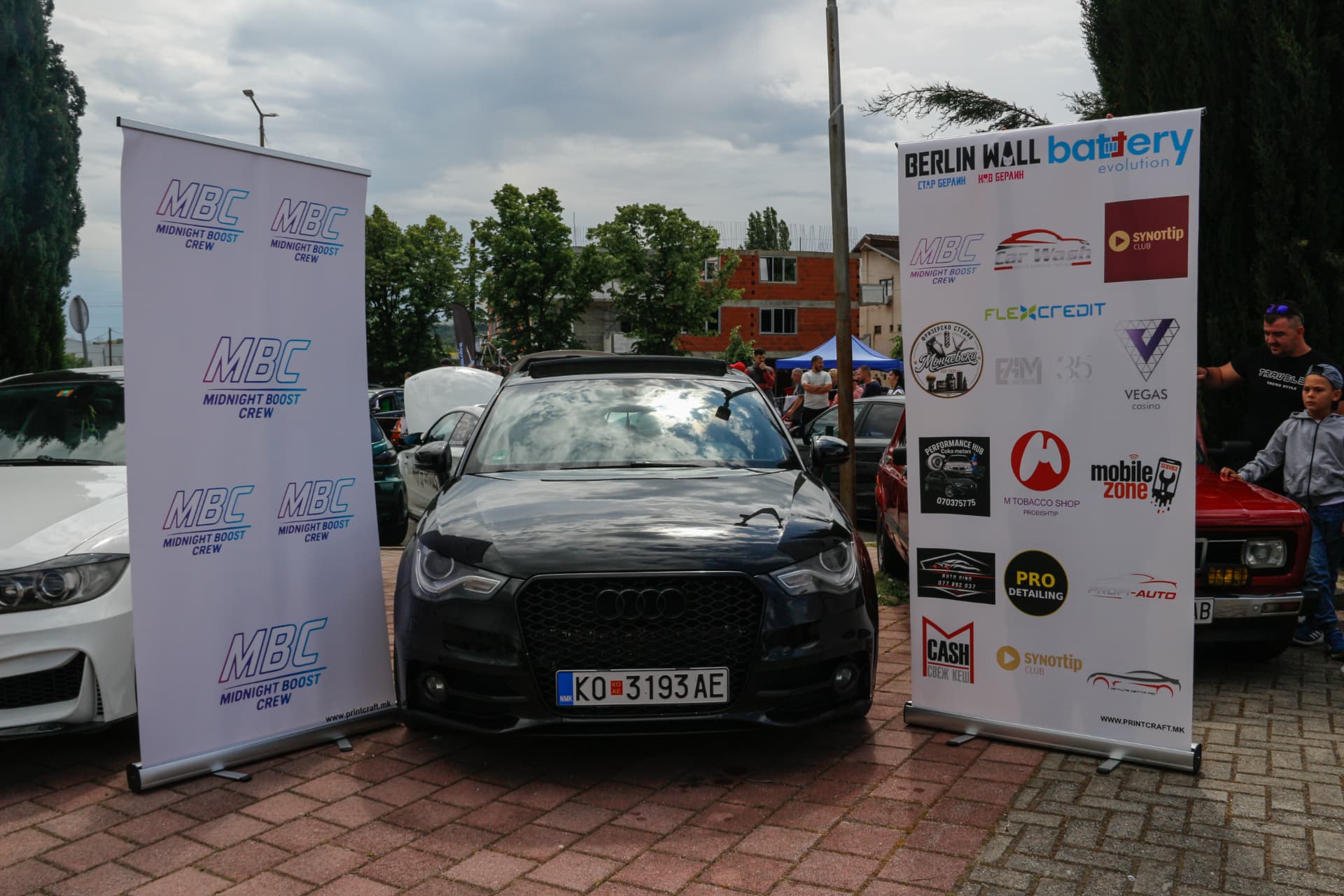 Black Audi A1 between MBC banners