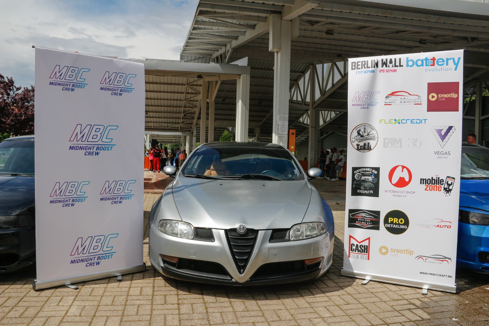 Silver Alfa Romeo between MBC banners