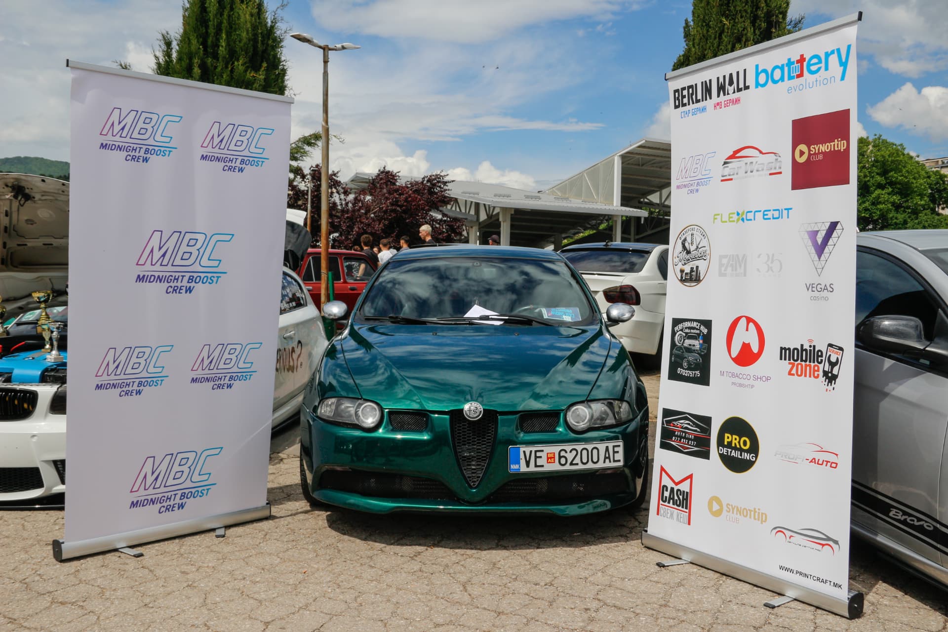 Green Alfa Romeo 147 between MBC banners