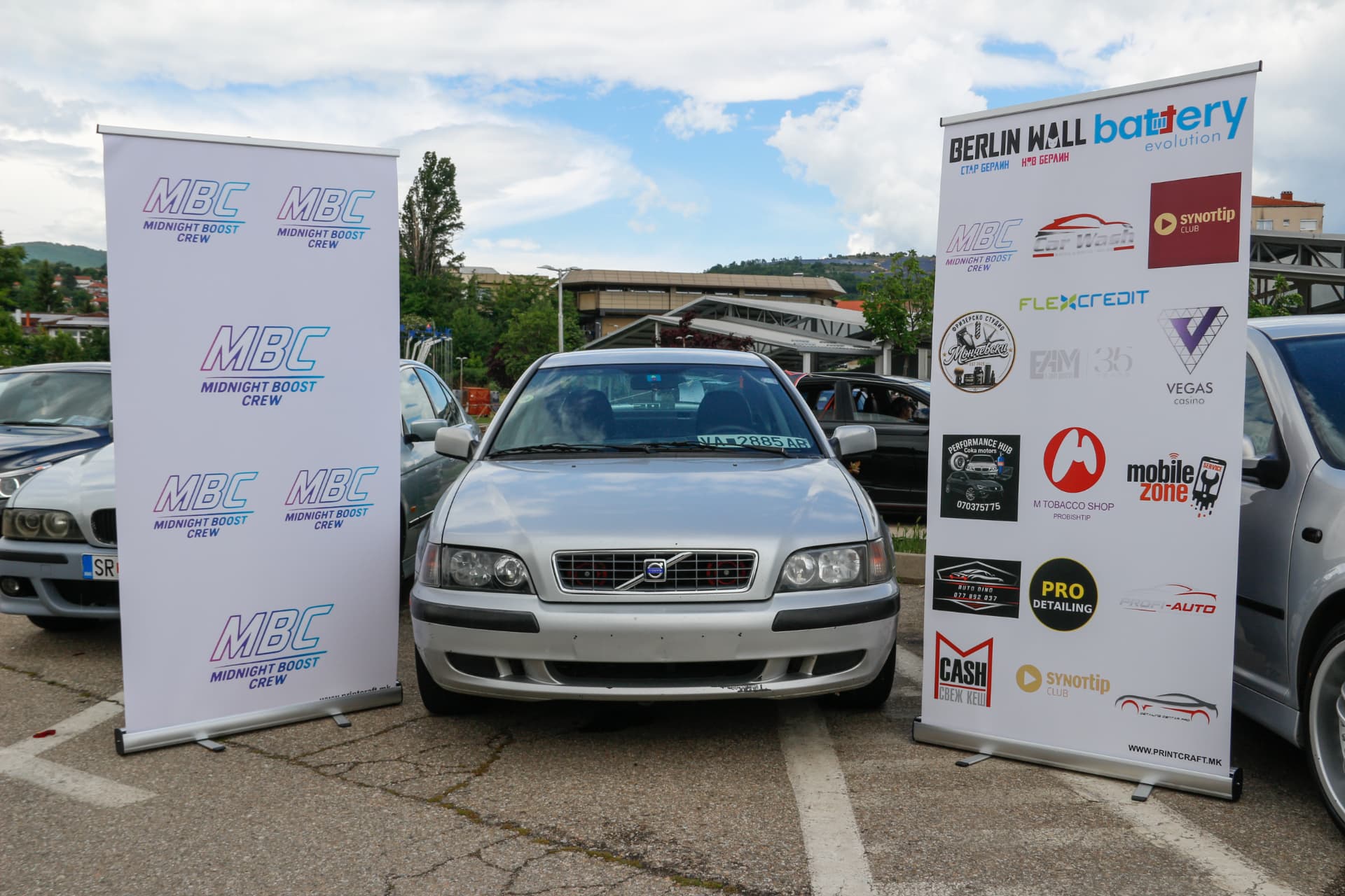 Silver Volvo S40 between MBC and sponsor banners