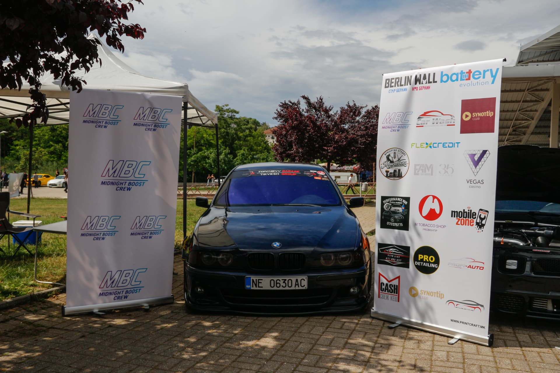 Black BMW E39 between MBC banners
