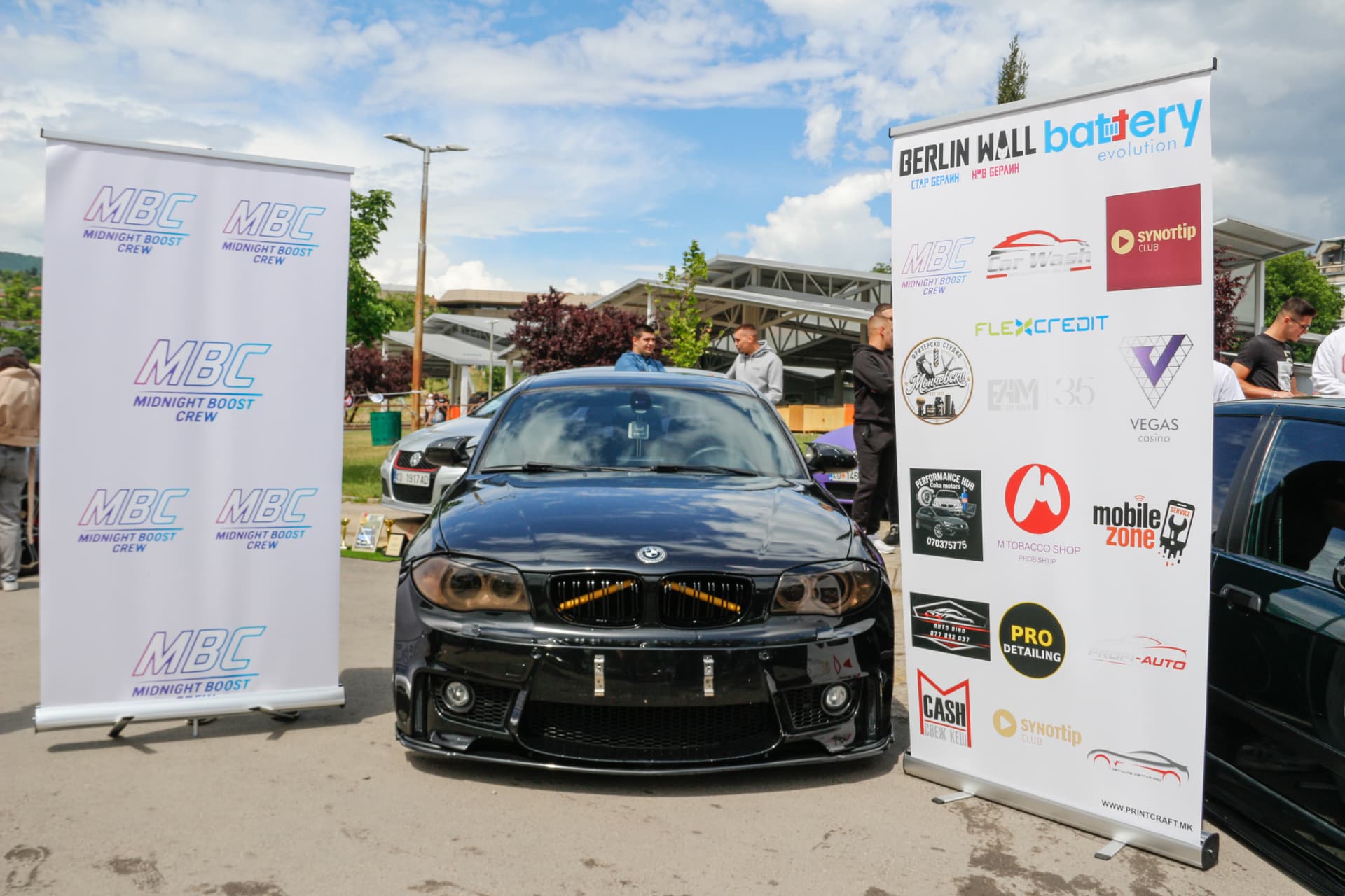 Black BMW 1-series between MBC banners
