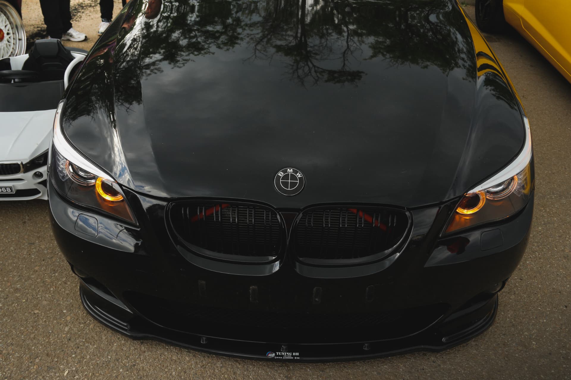 Black BMW E60 front with amber angel eyes