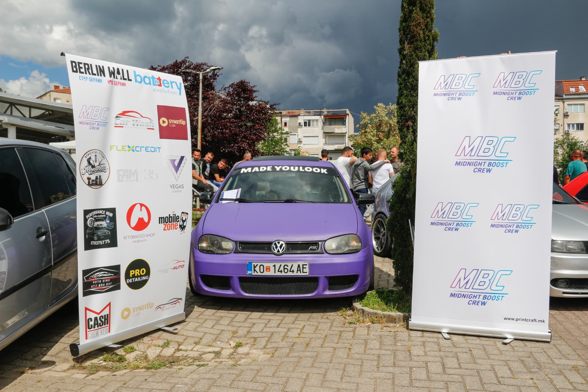 Purple VW Golf between MBC banners