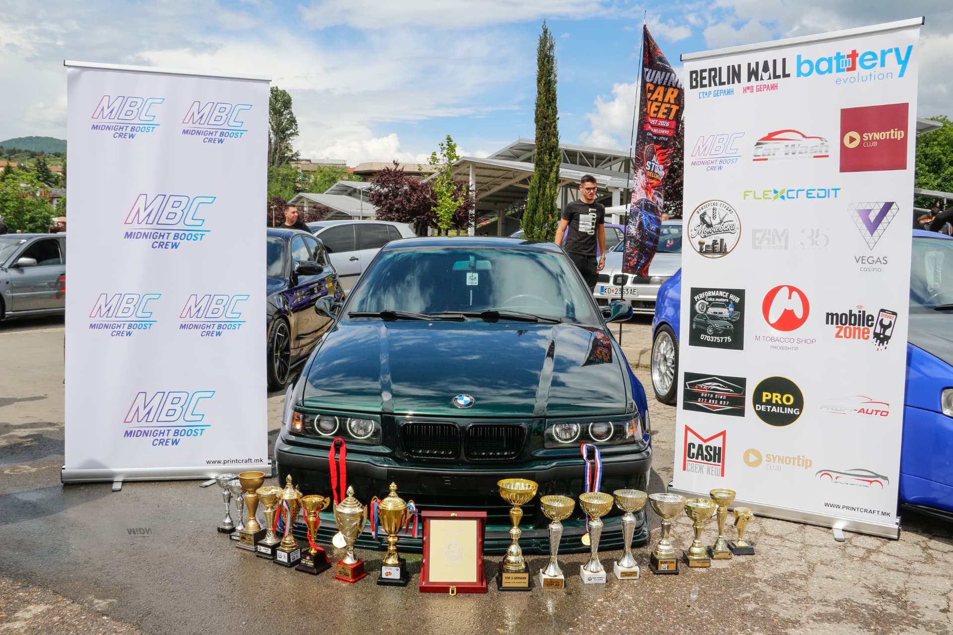 Green BMW E36 with trophies between MBC banners