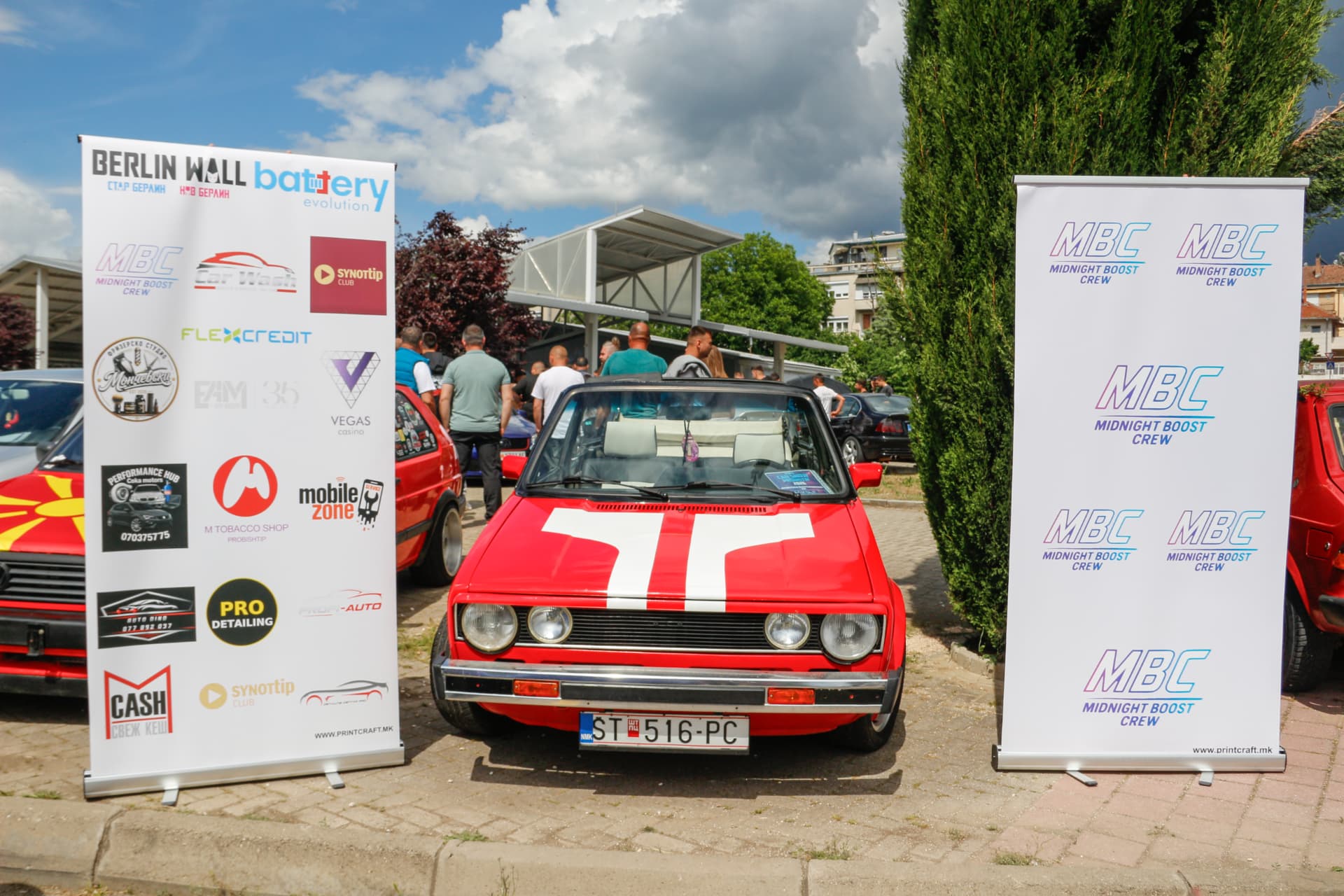Red MK1 Golf cabrio between MBC banners