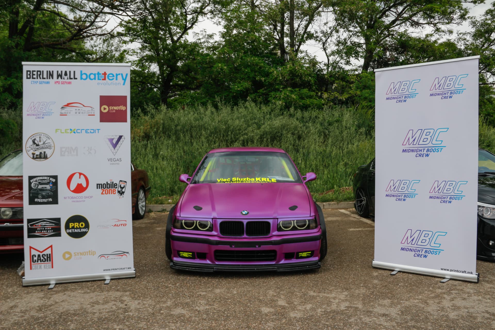 Purple widebody BMW E36 between MBC and sponsor banners