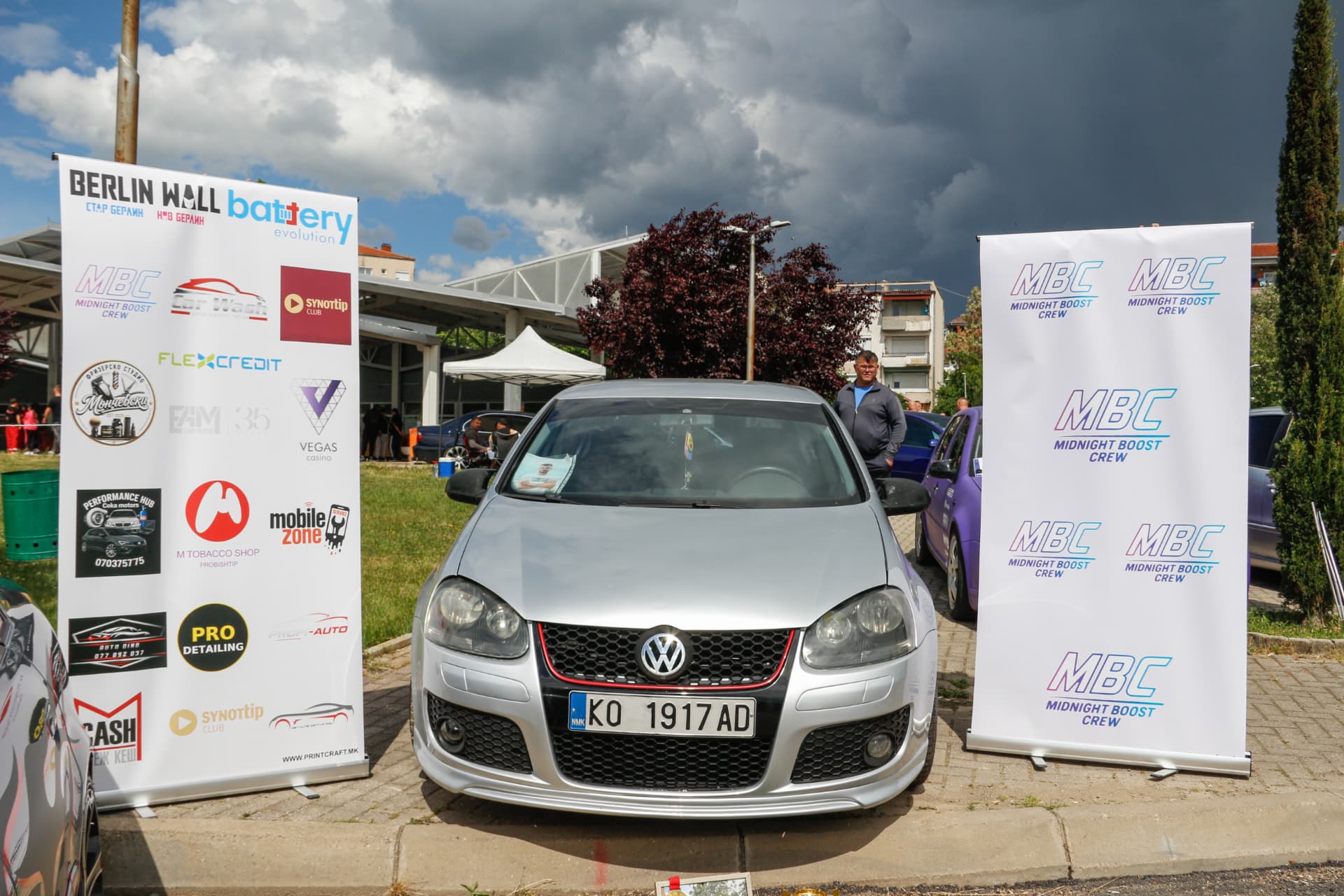 Silver VW GTI between MBC banners