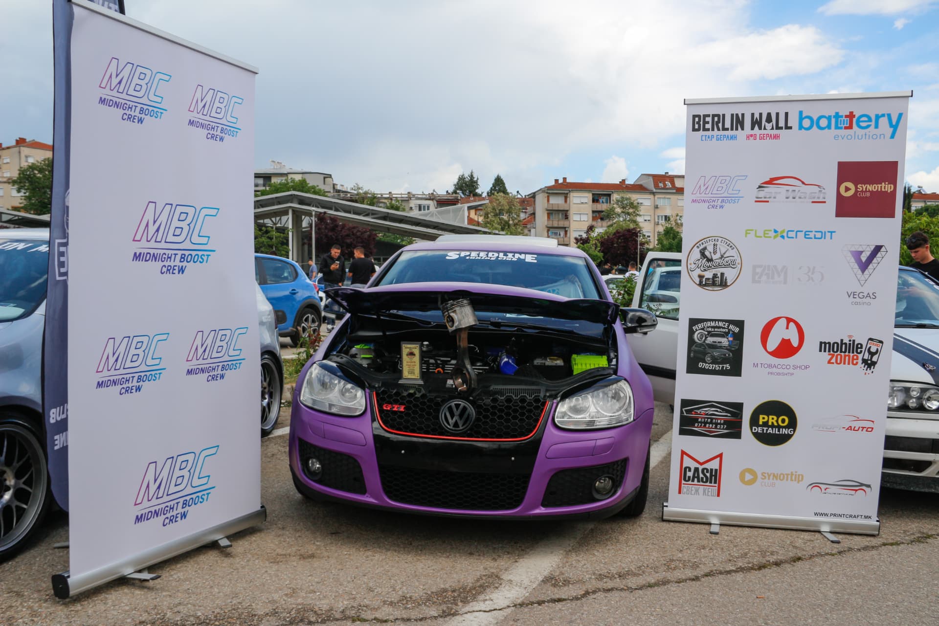 Purple VW Golf GTI with engine trophies