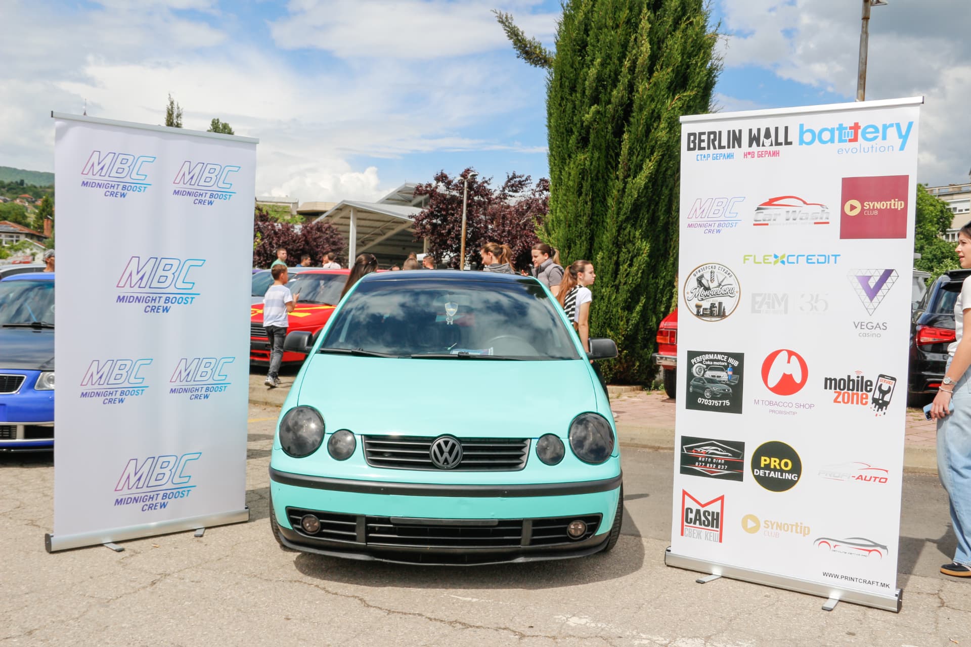 Mint green VW Polo between MBC banners