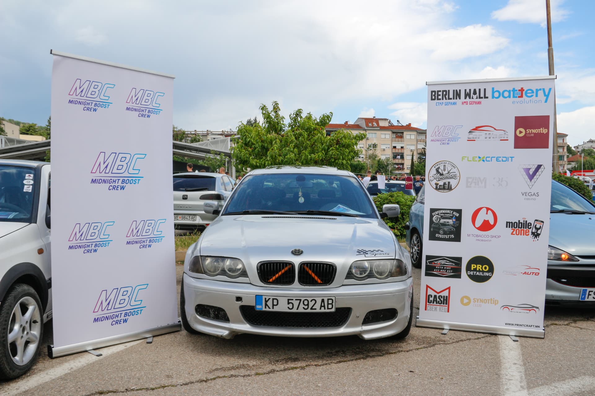 Silver BMW E46 between MBC banners