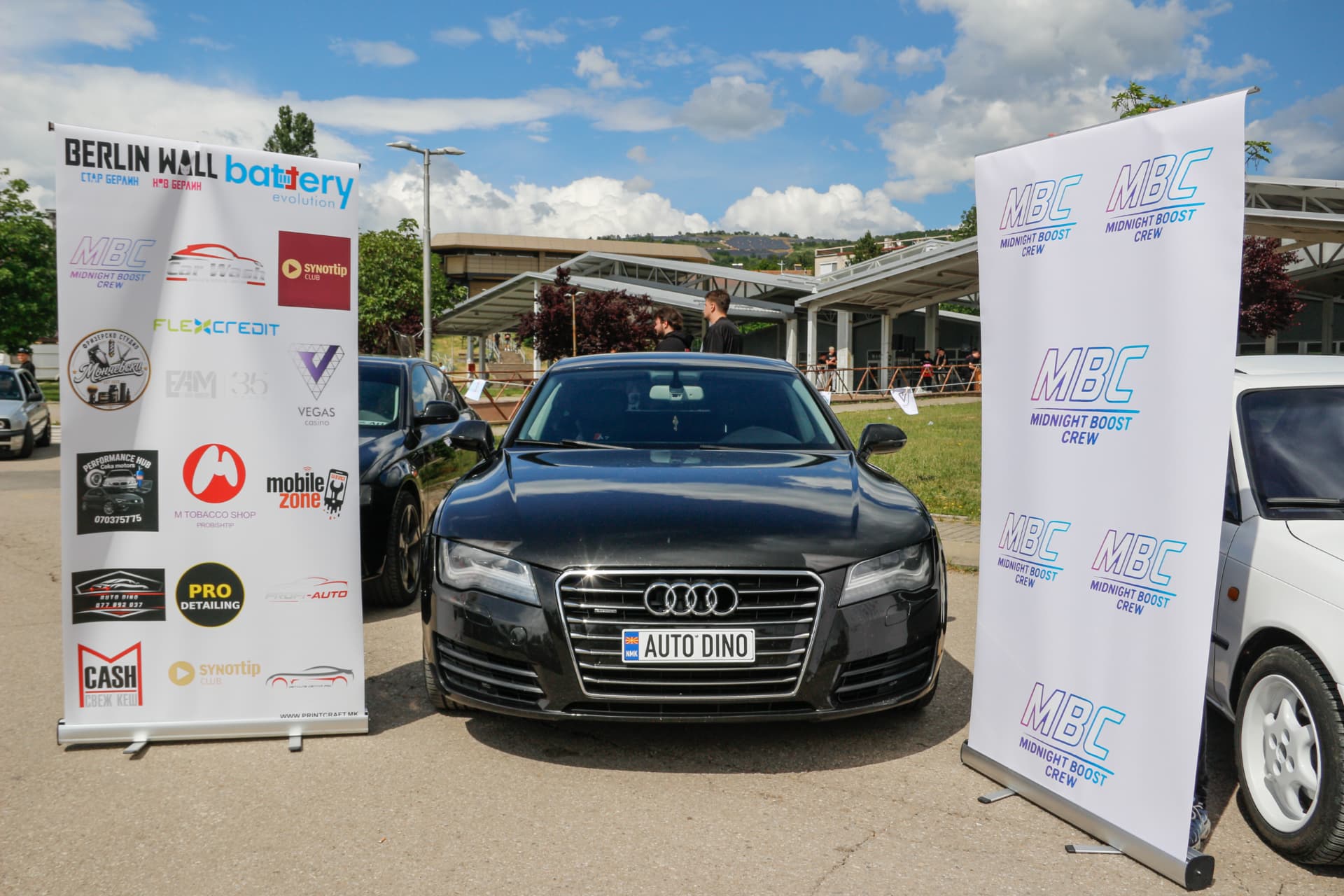 Black Audi A7 between MBC banners