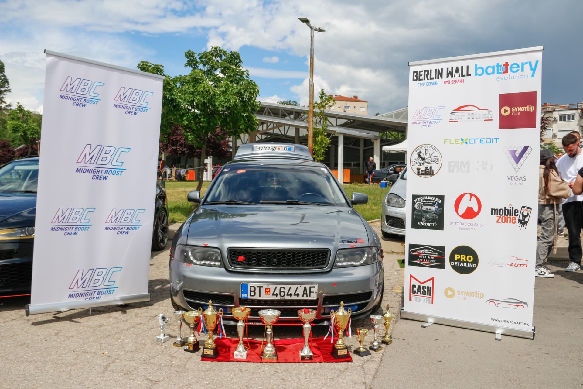 Grey Audi S4 with trophies on red carpet
