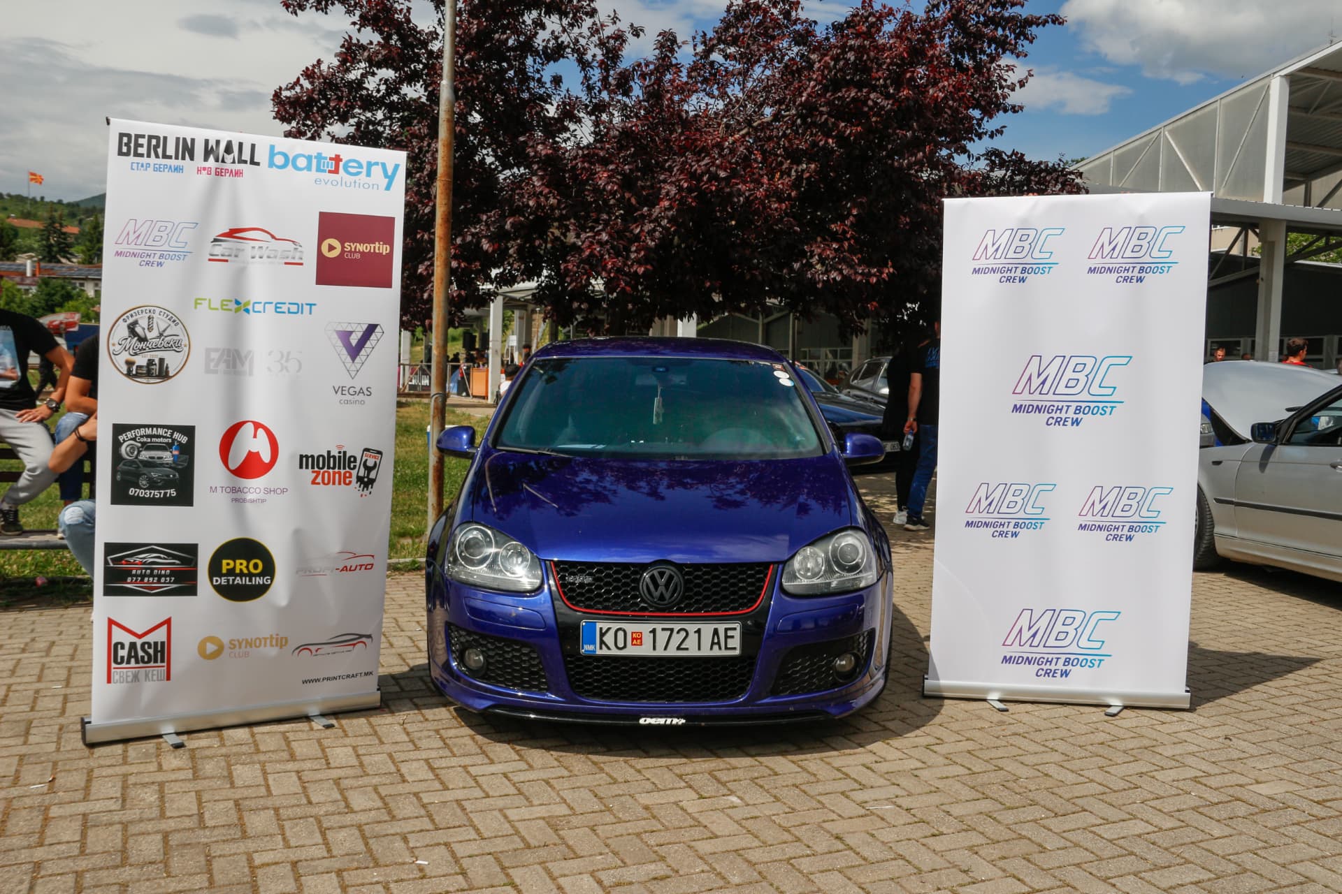 Blue VW GTI between MBC banners