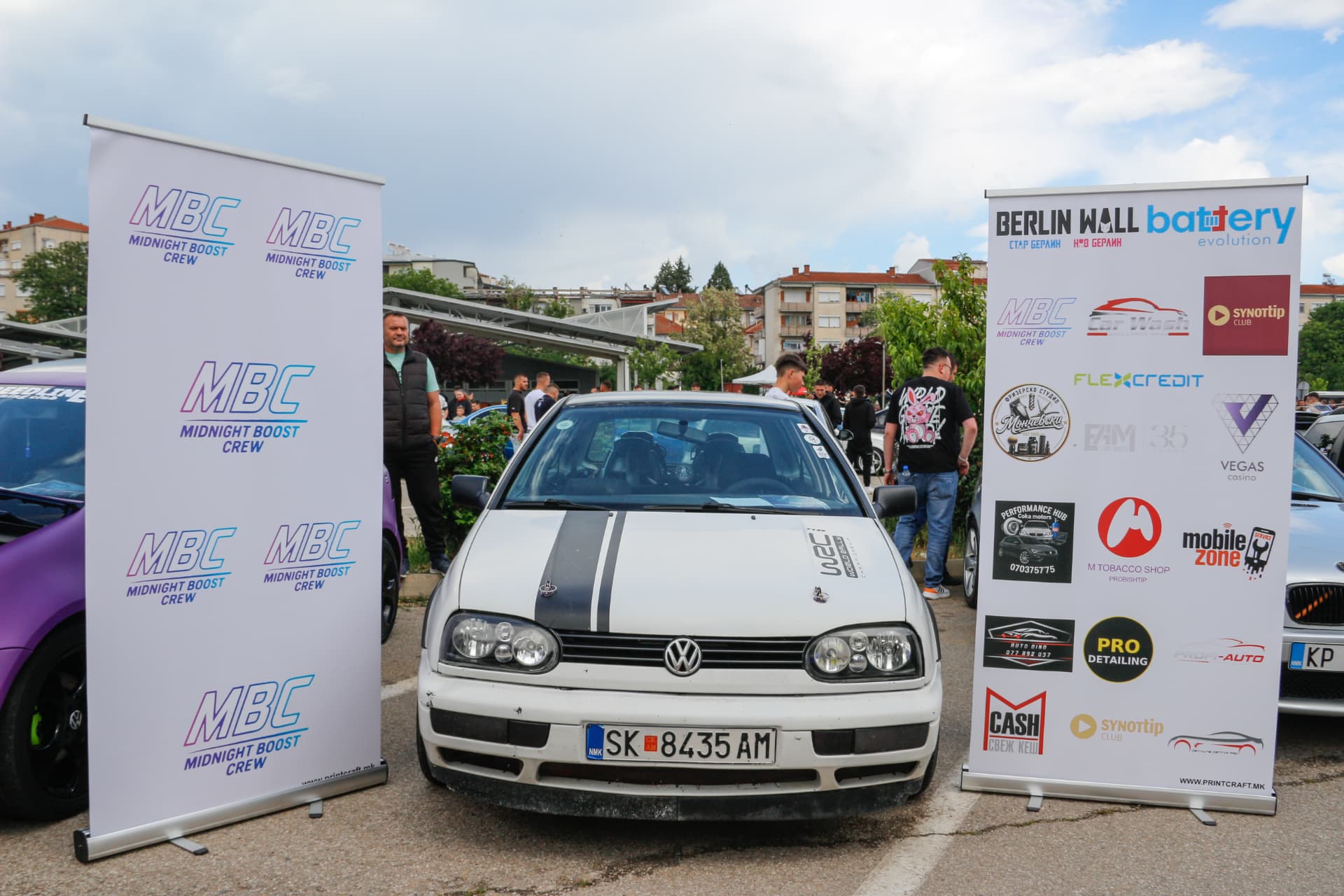 White VW Golf MK3 with black stripes between MBC banners