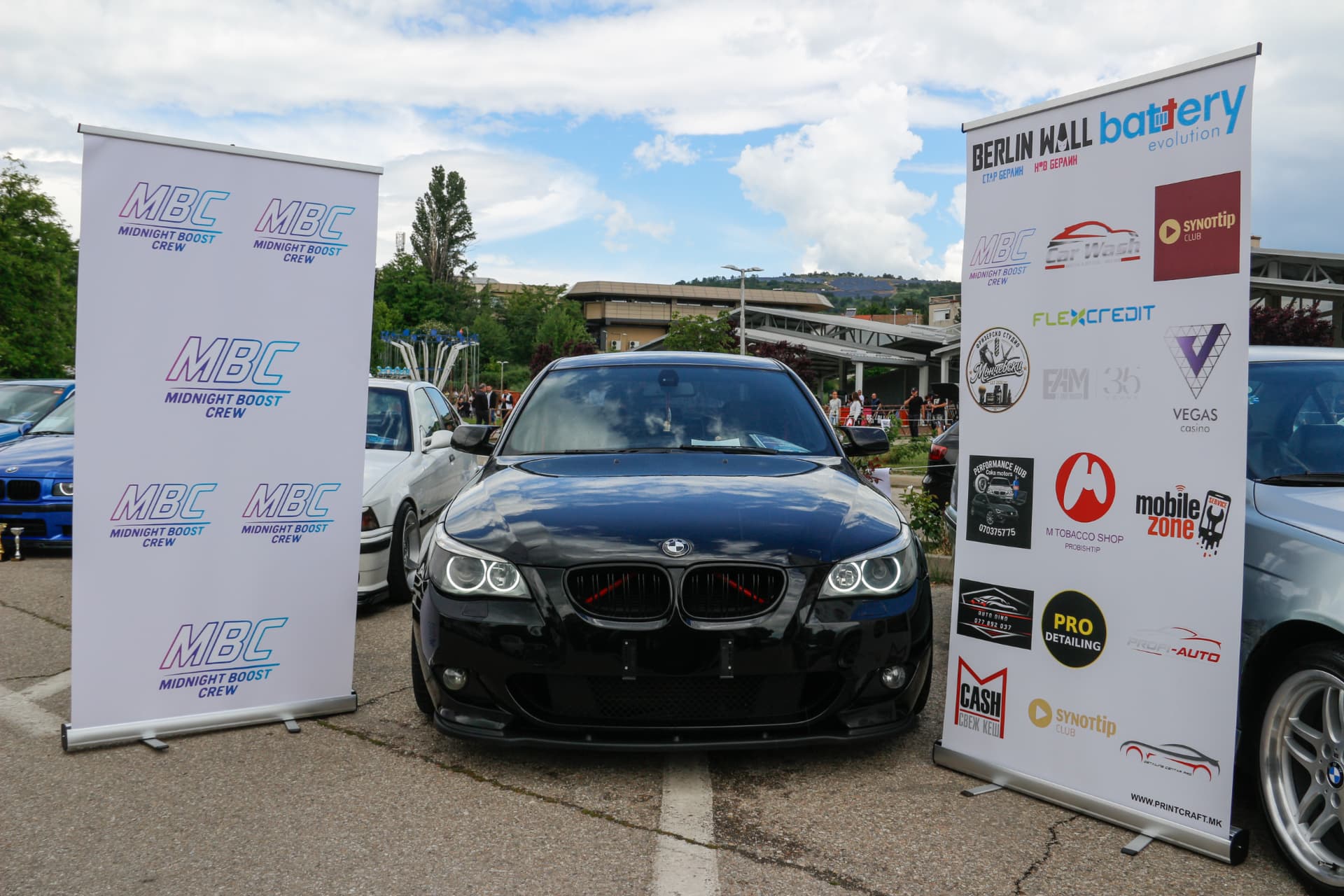 Black BMW E60 between MBC and sponsor banners